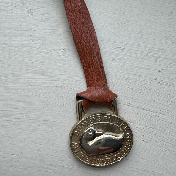 Dooney & Bourke Accessories - Dooney & Bourke Vintage Gold Emblem Leather Hangtag